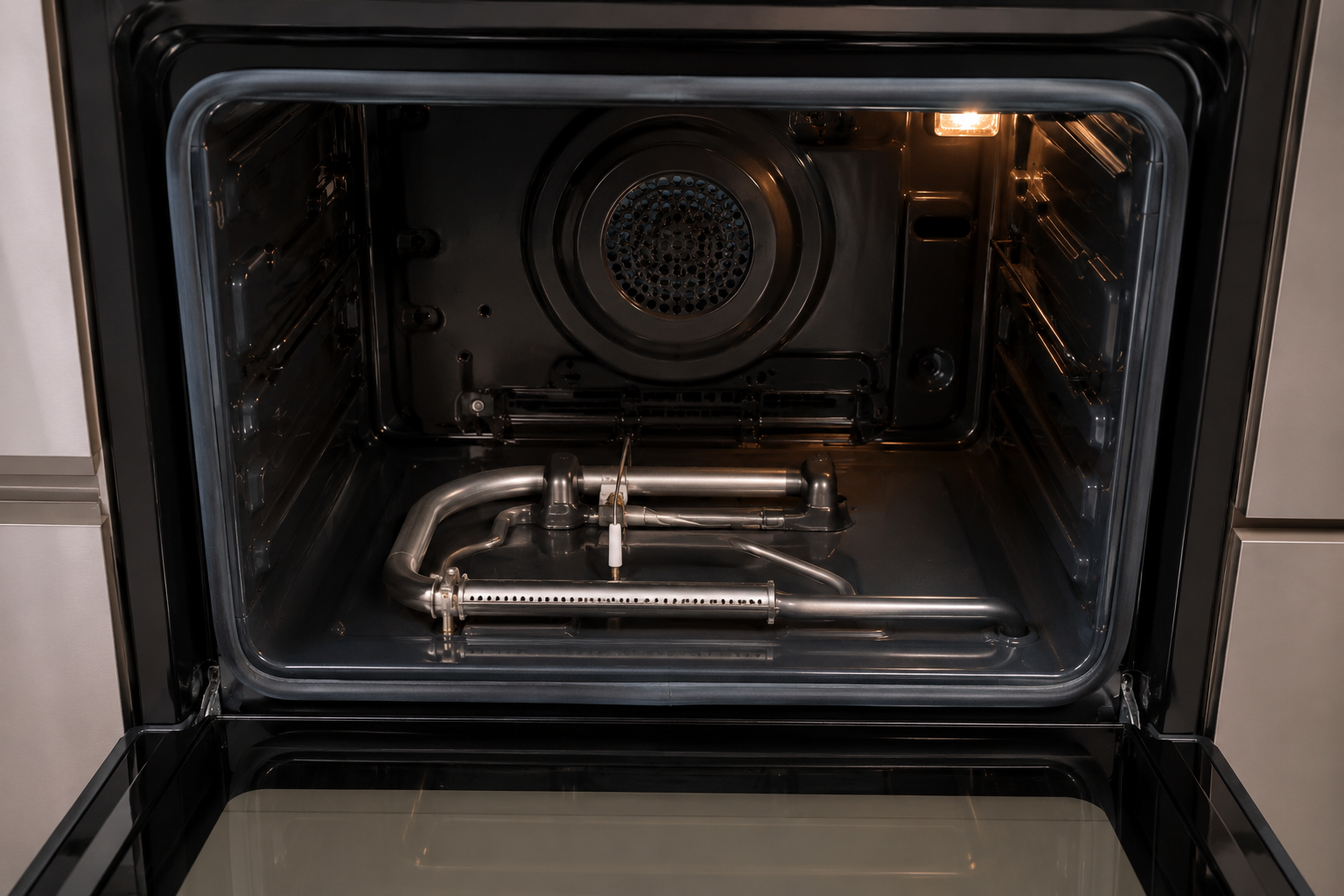 How to fix a gas oven - open interior view showing burner and igniter
