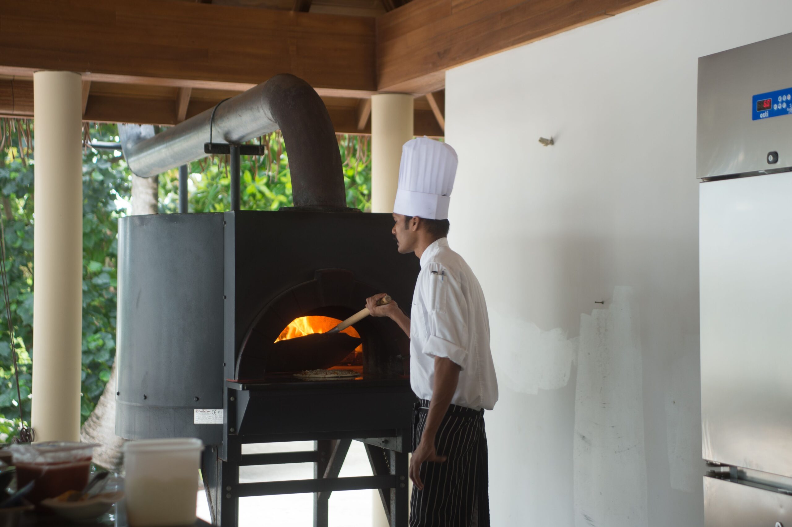 Chef working with a Sicilian oven in a traditional pizza kitchen